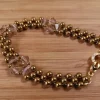 Tradera Armband i 4 mm, guldfärgade hematit pärlor o 6 mm bicone, glas klara kristaller> Selvdesignede Smykker