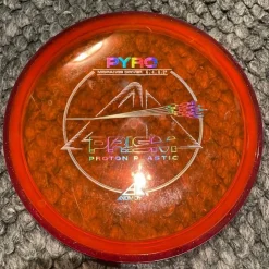 Tradera Axiom Pyro - 168g - Prism Proton Plastic> Discgolf