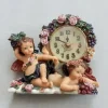 Tradera Bordsur / bordsklocka, figurklocka dekorerad med änglar och naturdetaljer.> Ure Til Hjemmet