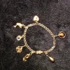 Tradera Guld armband 18K med berlocker> Armbånd
