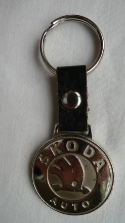 Tradera SKODA AUTO nyckelring i metall och läder i fint skick diameter 35 mm> Mobilia